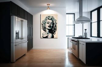Modern kitchen with black cabinets, stainless fridge, and a Marilyn Monroe portrait on a white wall.