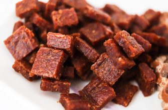 Small cubes of beef jerky on a white plate