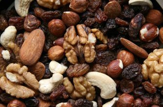 Close-up of mixed nuts and dried fruit: walnuts, almonds, hazelnuts, cashews, and raisins in a snack mix