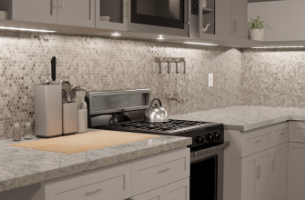 Modern kitchen with gray cabinets, hex tile backsplash, and stainless steel appliances including a gas stove and microwave; kettle on the stove.